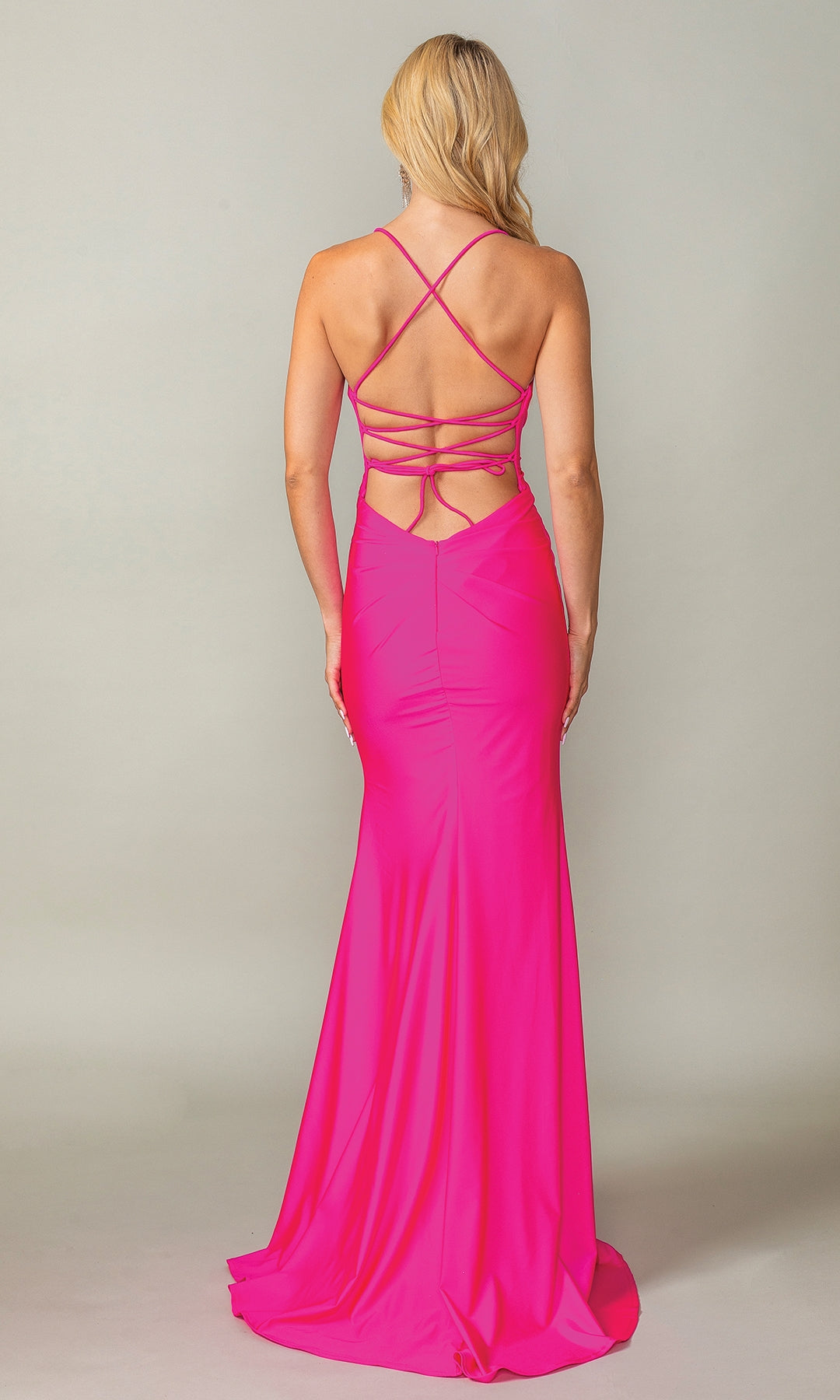 A woman faces away from the camera wearing the Fuchsia Pink Beaded Long Prom Dress 4405—a fitted, floor-length gown with a crisscross open back.